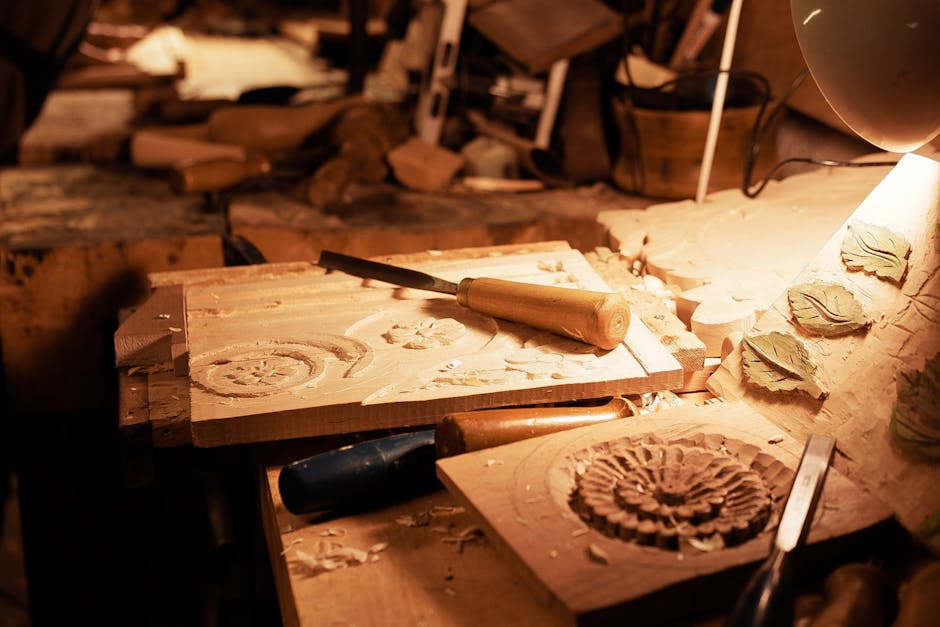 Detailed image of hand-carved wooden panels on a workbench, showcasing traditional woodworking techniques.