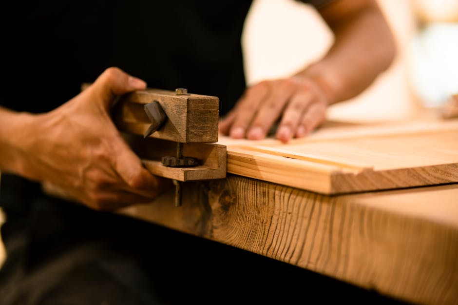 A skilled woodworker shaping wood with a hand tool in a workshop, showcasing craftsmanship and precision.