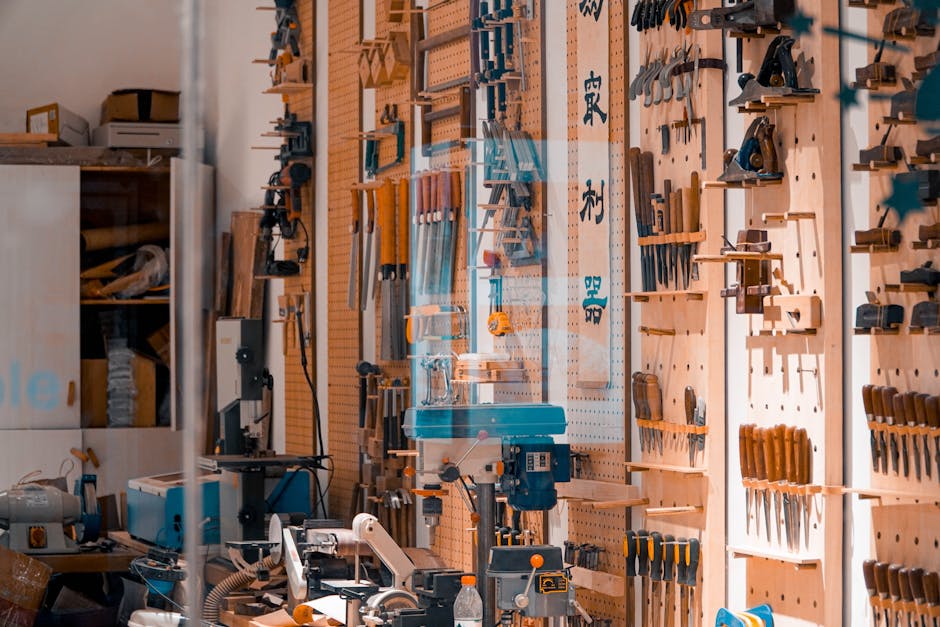 A well-organized workshop featuring an array of tools neatly displayed on wooden boards.