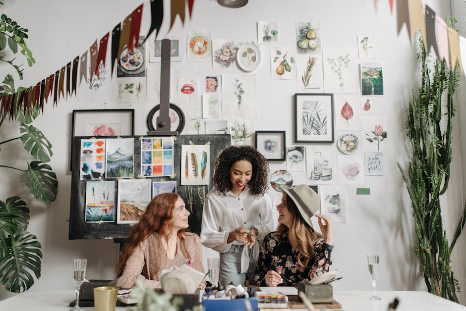 Three women enjoying a creative art workshop with paintings and plants around them.