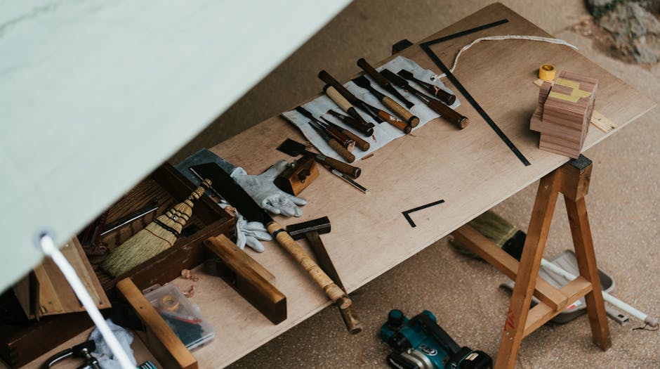 A wooden workbench with various traditional woodworking tools, showcasing artistic craftsmanship and fine woodworking skills.